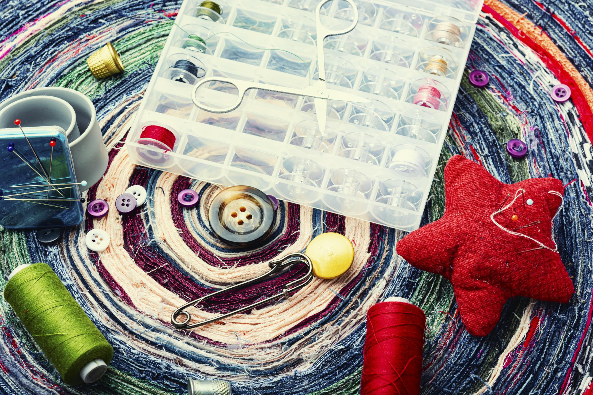 flatlay of embroidered labels and thread spools used for subscription packages