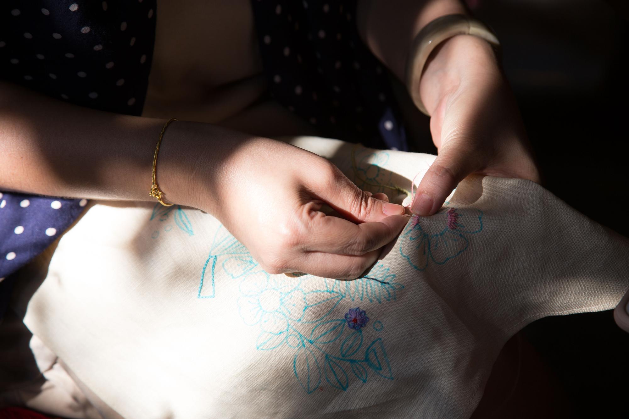studio artisan trimming fabric by hand